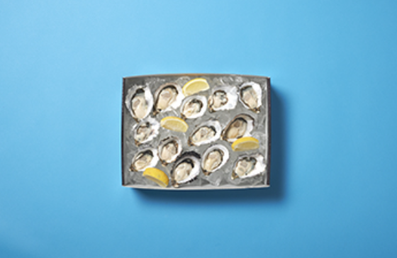 Oyster box filled with oysters on ice